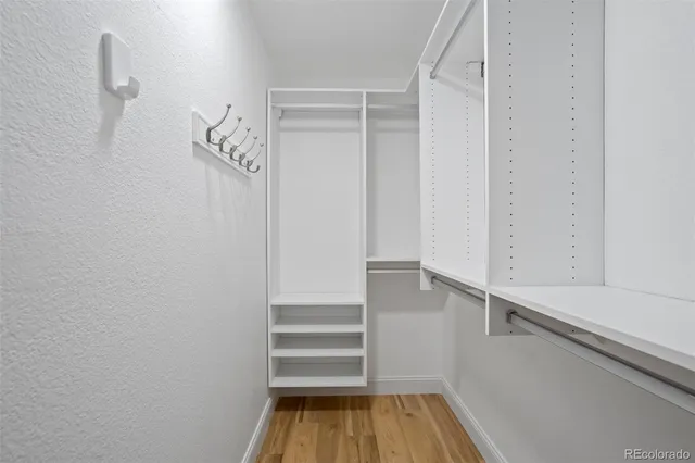 a view of walk in closet with empty racks