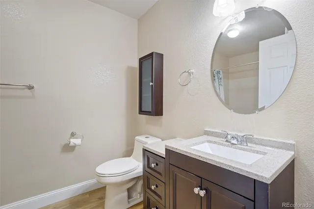 a bathroom with a sink a mirror and a toilet
