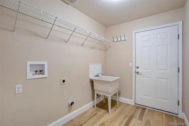 a view of a room with wooden floor a table and chairs