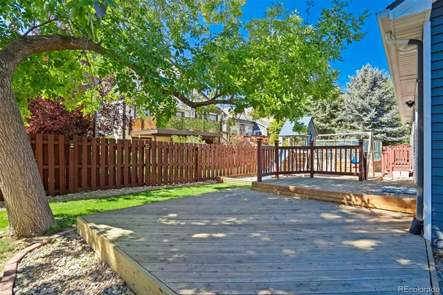 a view of a yard with wooden fence