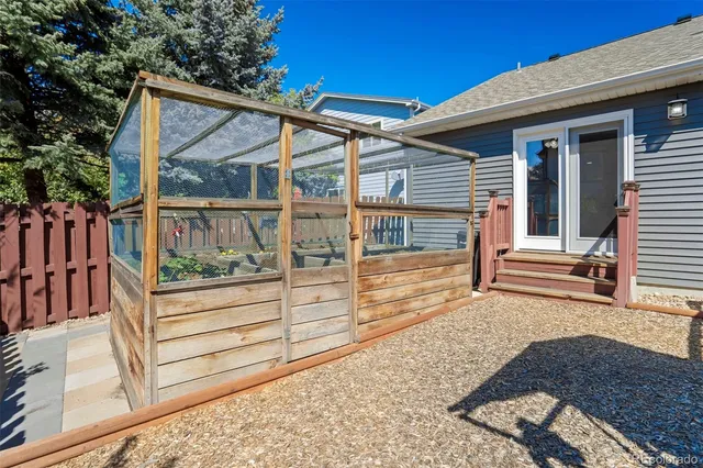 a view of a house with backyard and deck