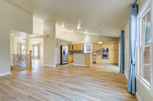 a view of a kitchen with wooden floor and a kitchen