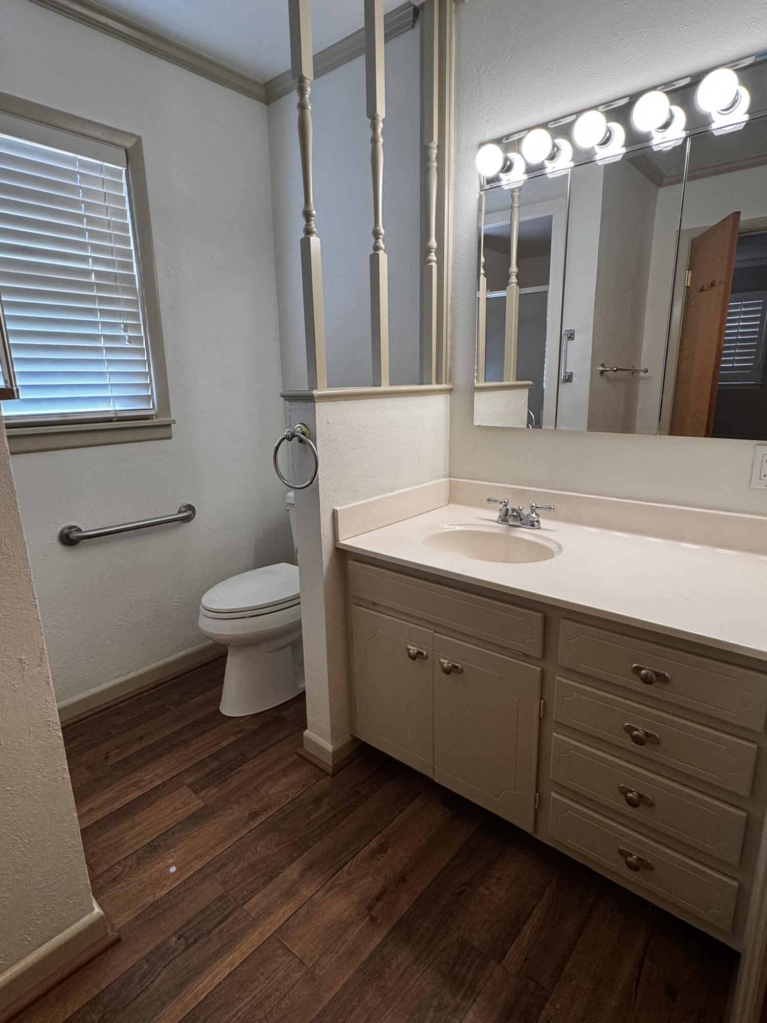 1304 Floydada Plainview, TX 79072 - Photo 24 of 49 a spacious bathroom with a double vanity sink a toilet and a mirror