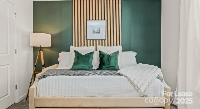 a bedroom with a bed and a lamp on table