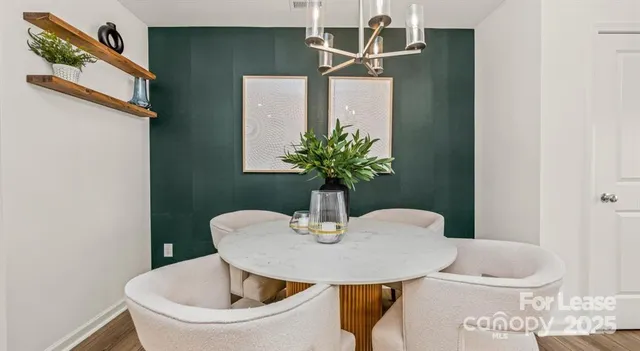 a dining room with furniture and wooden floor