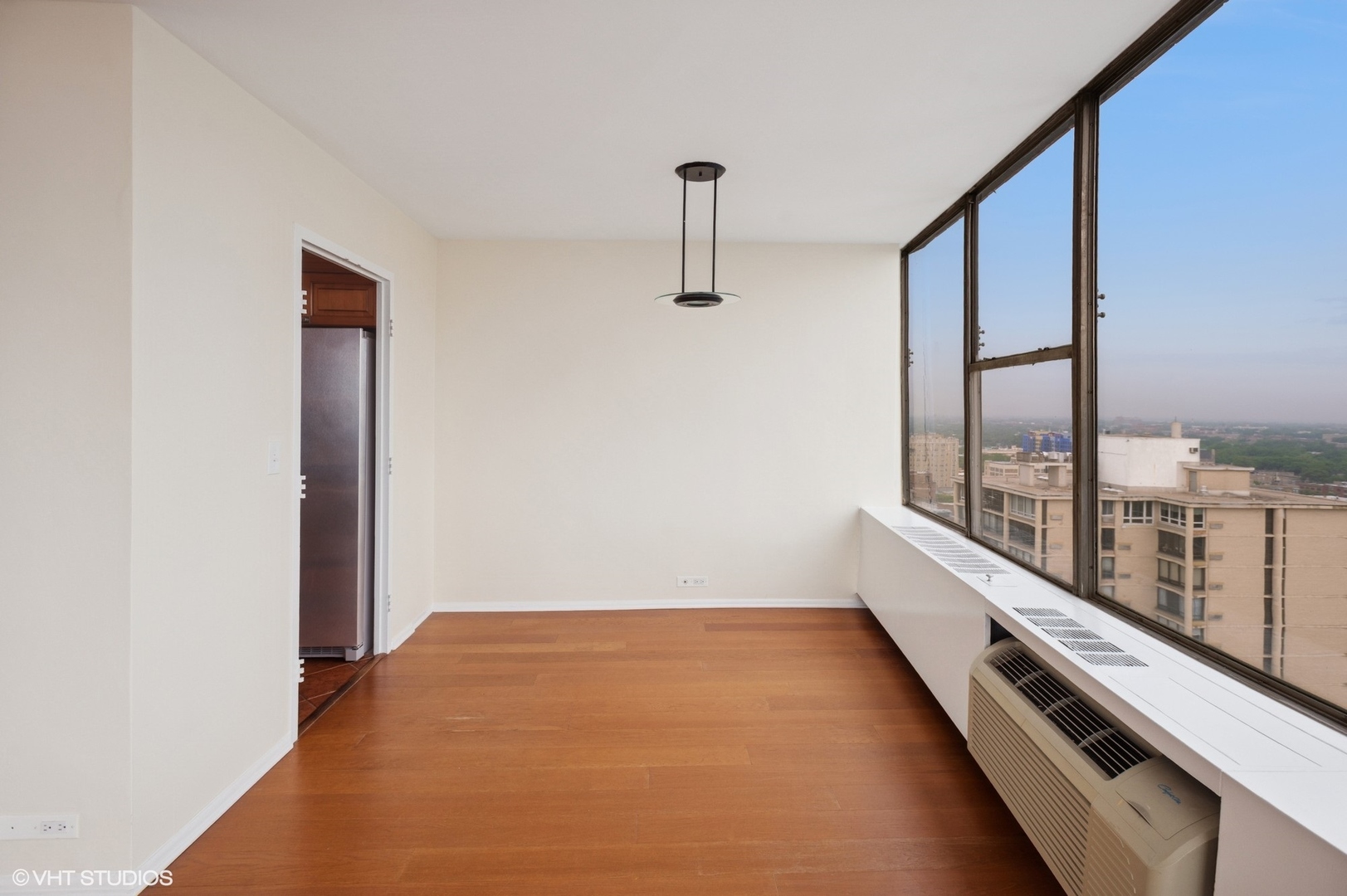 5757 North Sheridan Road, Unit 20J Chicago, IL 60660 - Photo 5 of 20 an empty room with windows