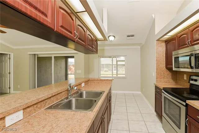a kitchen with a sink and a stove top oven