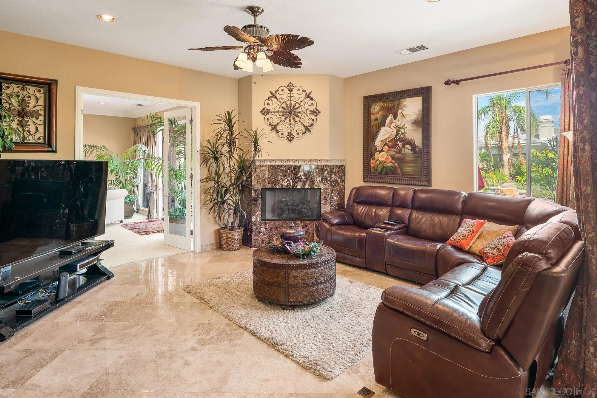 4 Chandon Court Rancho Mirage, CA 92270 - Photo 18 of 44 a living room with furniture a flat screen tv and a large window