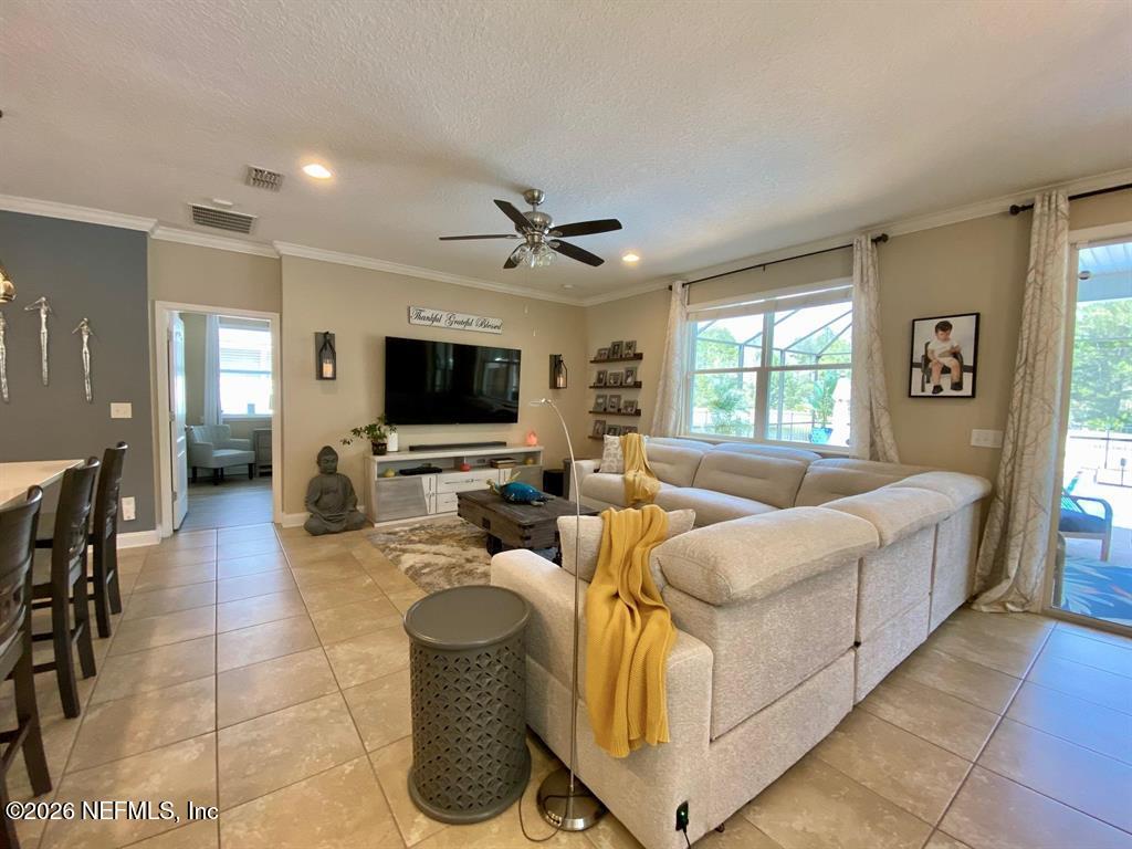 115 Sierras Loop St. Augustine, FL 32086 - Photo 14 of 65 a living room with furniture and a flat screen tv