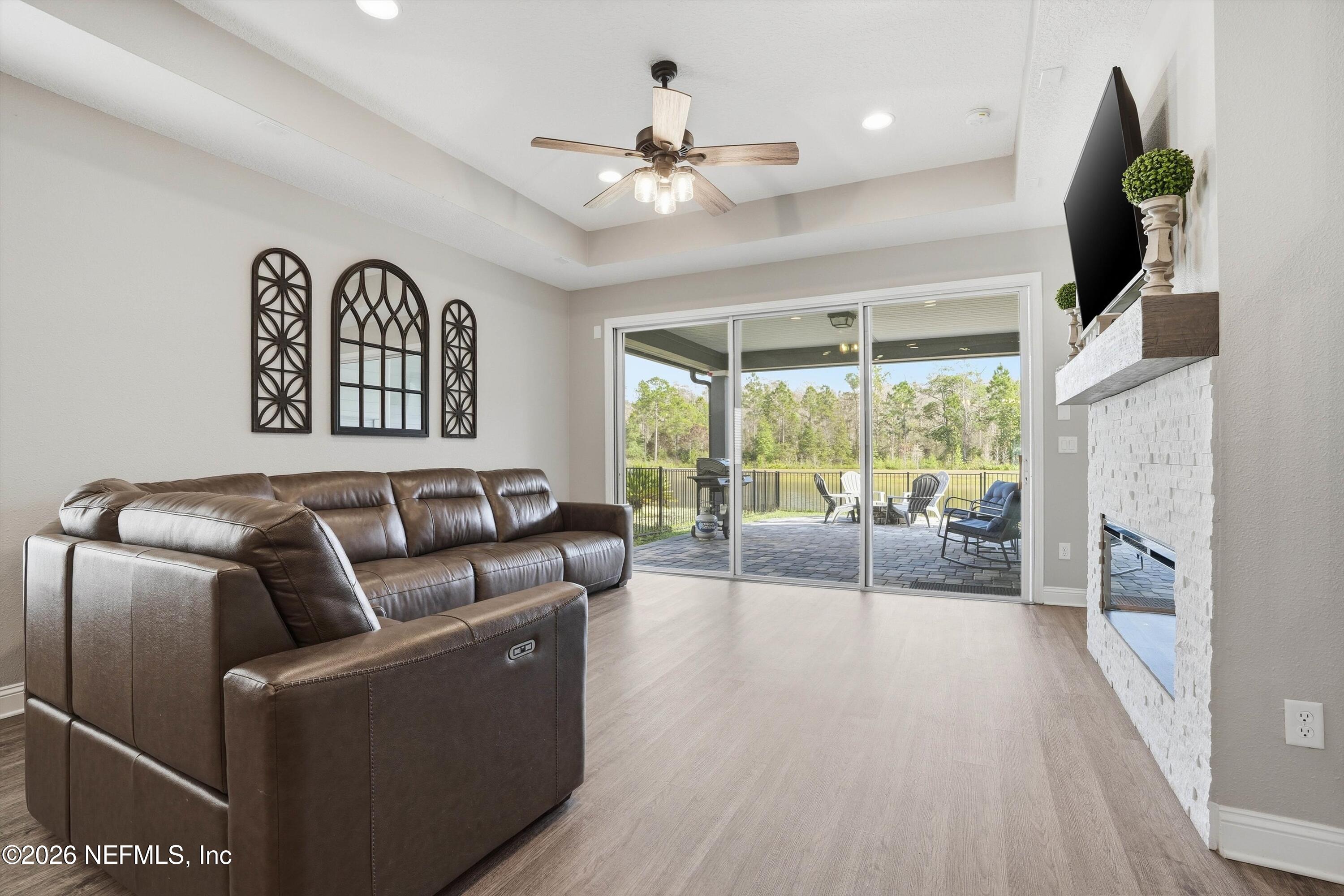 742 Sycamore Way Orange Park, FL 32073 - Photo 11 of 41 a living room with furniture fireplace and a large window