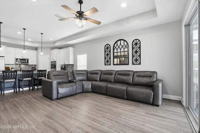 a living room with furniture and kitchen view
