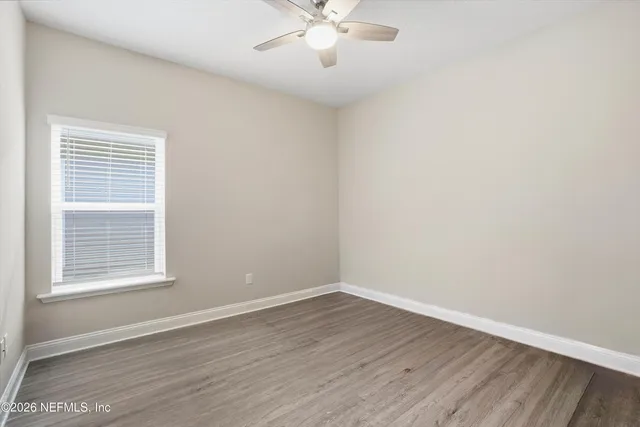 wooden floor in an empty room with a window