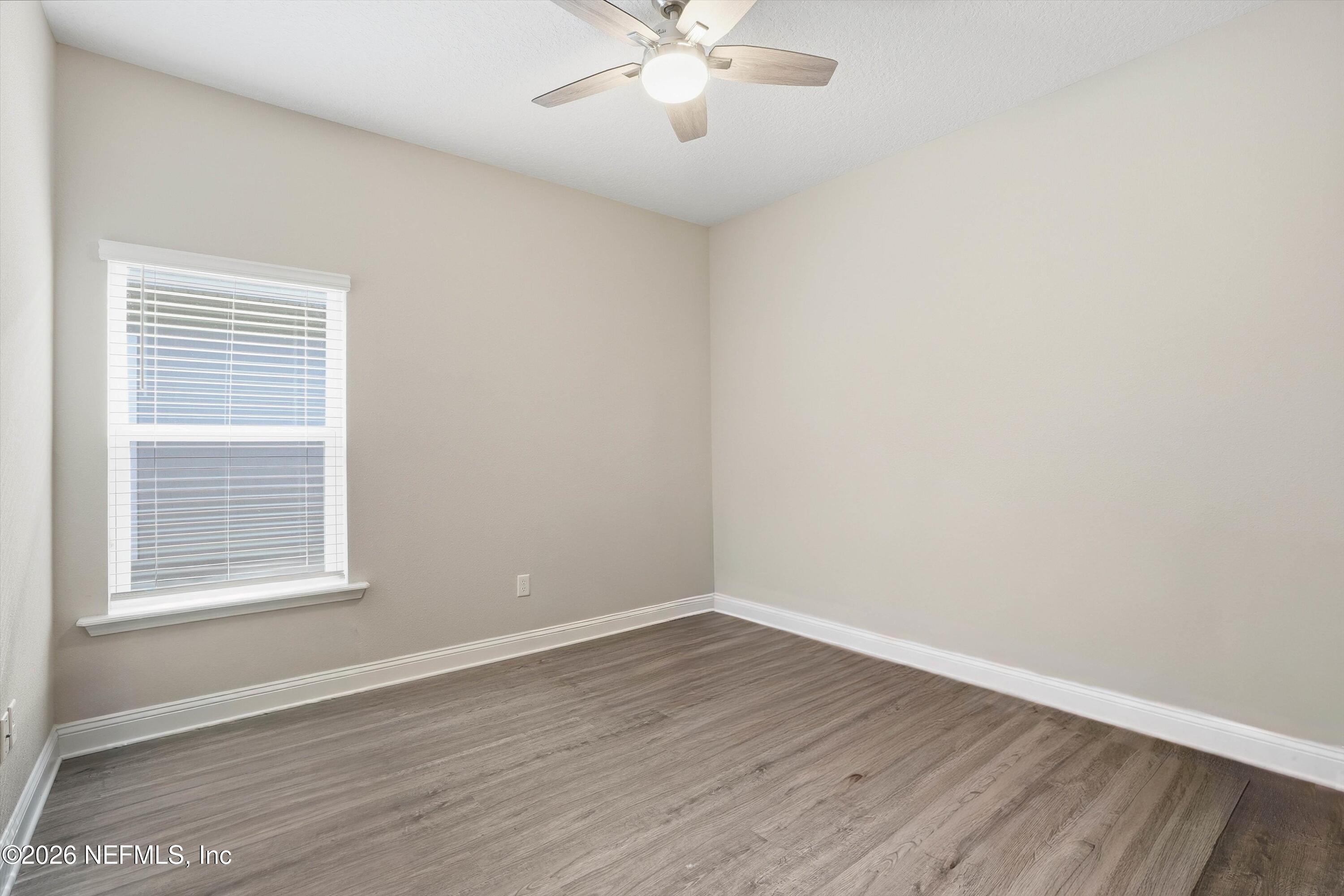 742 Sycamore Way Orange Park, FL 32073 - Photo 19 of 41 wooden floor in an empty room with a window