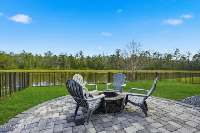 a view of a lake with furniture and garden