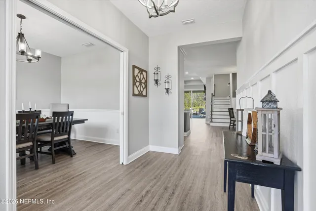 a view of a hallway with furniture and wooden floor