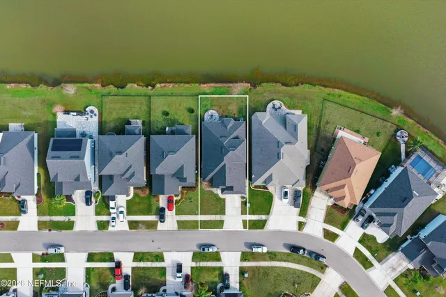 an aerial view of a house with a lake view
