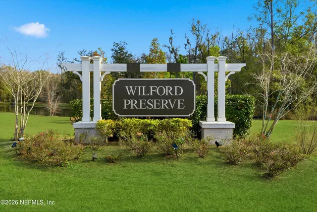 a front view of building with yard and outdoor seating