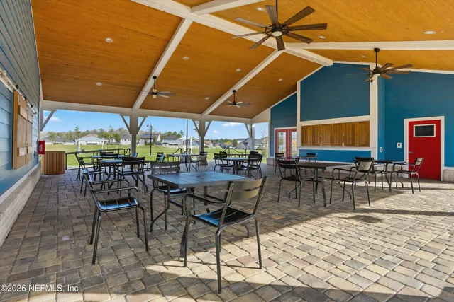 a view of a swimming pool with a lawn chairs under an umbrella