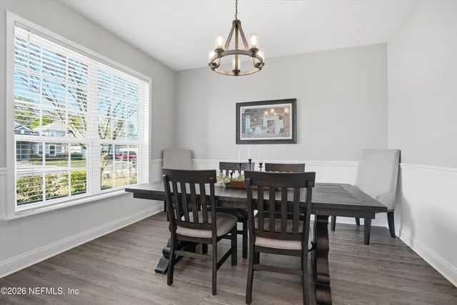 a view of a dining room with furniture window and wooden floor