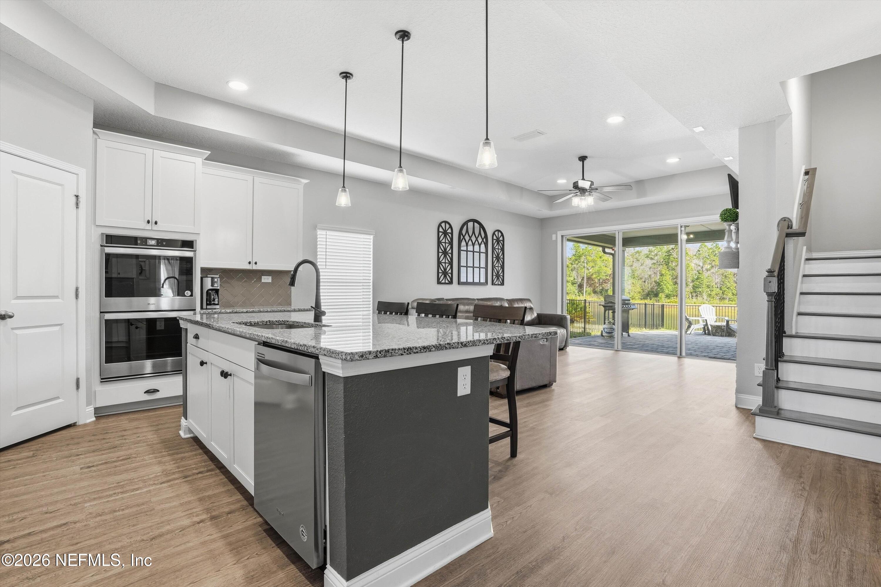 742 Sycamore Way Orange Park, FL 32073 - Photo 5 of 41 a large kitchen with stainless steel appliances kitchen island granite countertop a large center island attached withe living room