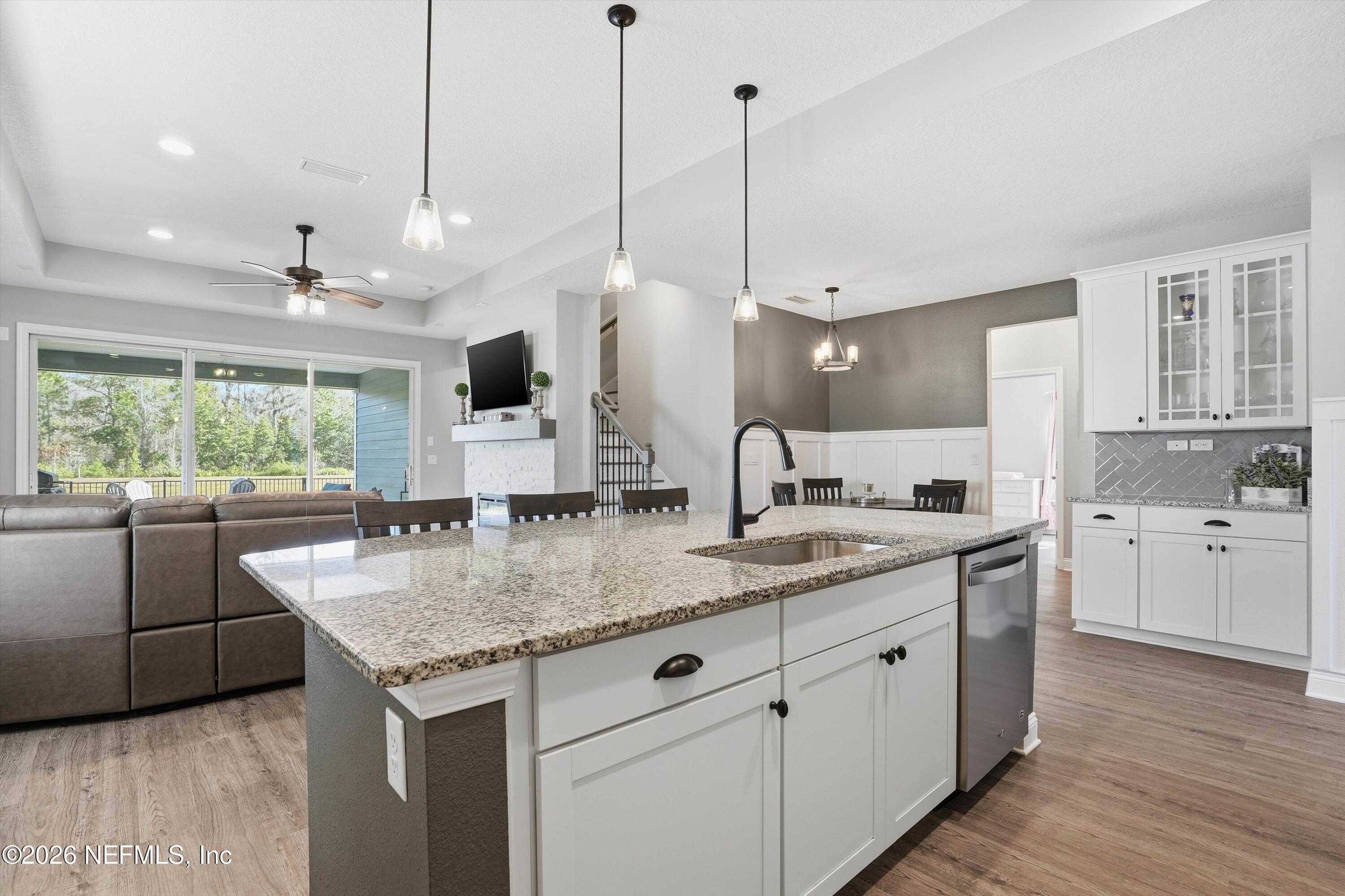 742 Sycamore Way Orange Park, FL 32073 - Photo 6 of 41 a kitchen with stainless steel appliances granite countertop a sink a island a stove and a wooden floor