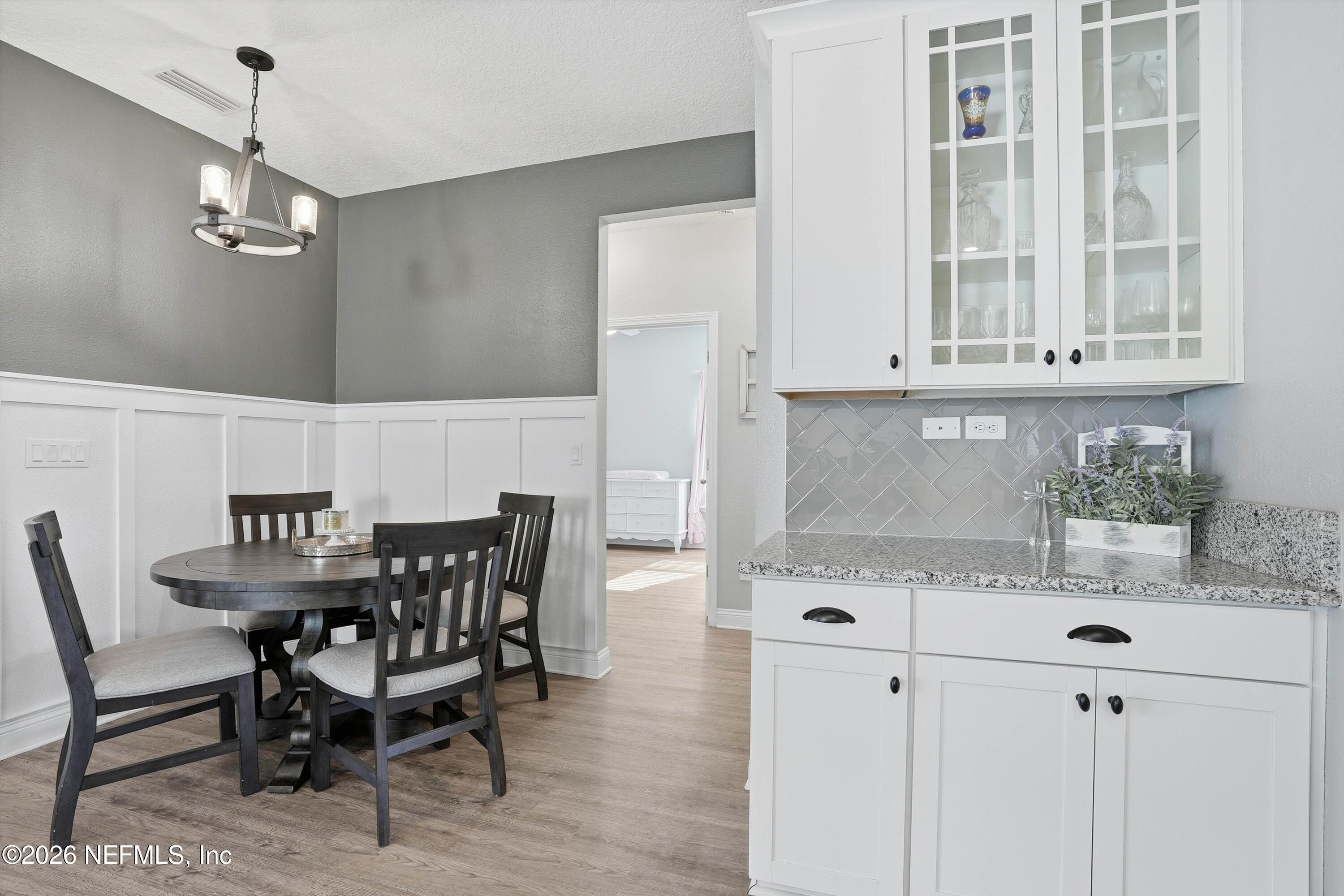 742 Sycamore Way Orange Park, FL 32073 - Photo 9 of 41 a view of a dining room with furniture and wooden floor