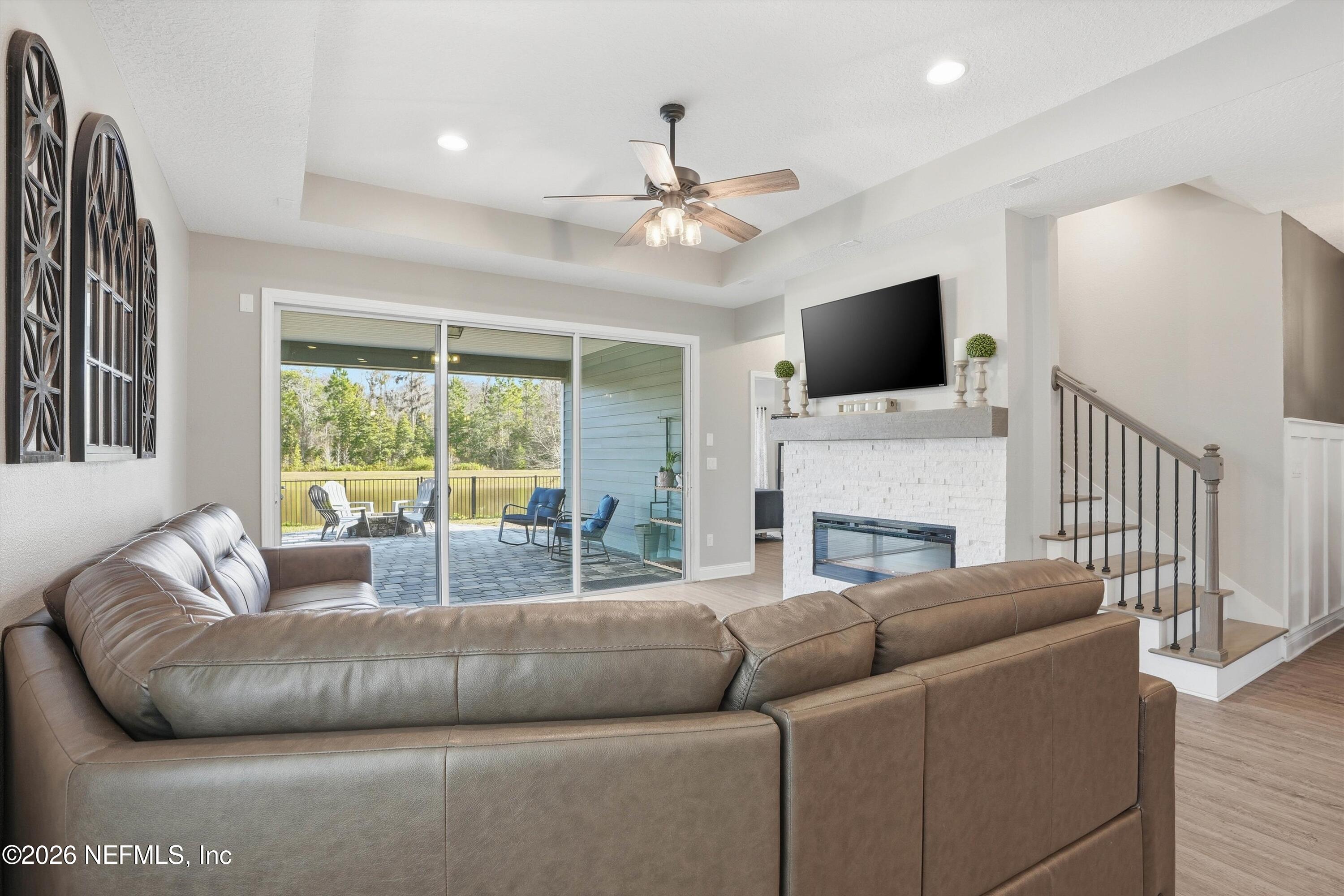 742 Sycamore Way Orange Park, FL 32073 - Photo 10 of 41 a living room with furniture a flat screen tv and a fireplace