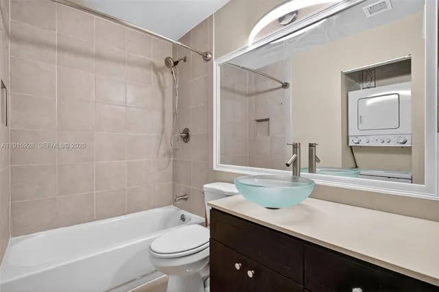 a bathroom with a sink a toilet a mirror and shower