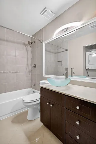 a bathroom with a double vanity sink toilet mirror and bathtub