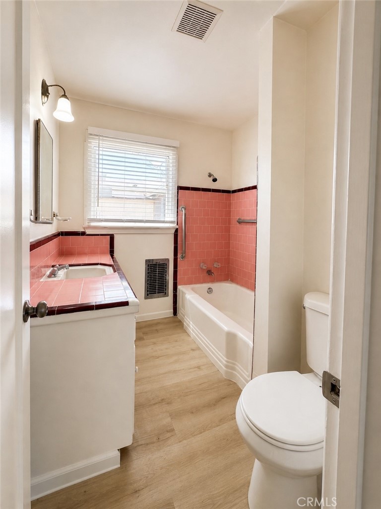 325 North Sanders Street Ridgecrest, CA 93555 - Photo 15 of 23 a bathroom with a granite countertop toilet sink and mirror