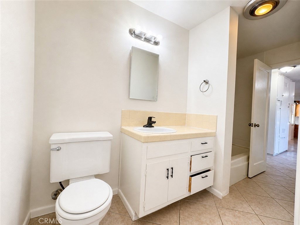 325 North Sanders Street Ridgecrest, CA 93555 - Photo 4 of 23 a bathroom with a toilet sink vanity and mirror