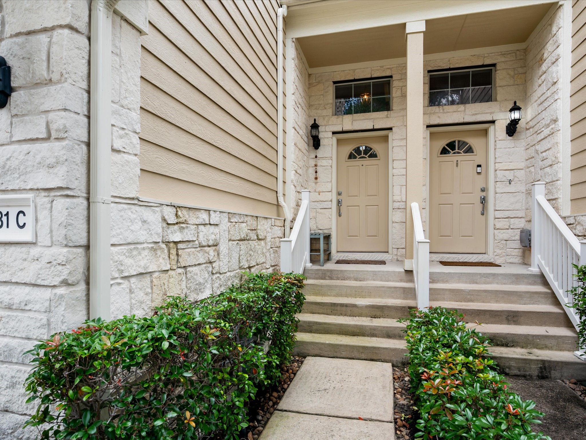 13600 Breton Ridge Street, Unit 31C Houston, TX 77070 - Photo 7 of 31 A private front entrance welcomes you home, with elevated steps leading to the front door and adding to the home's inviting curb appeal.