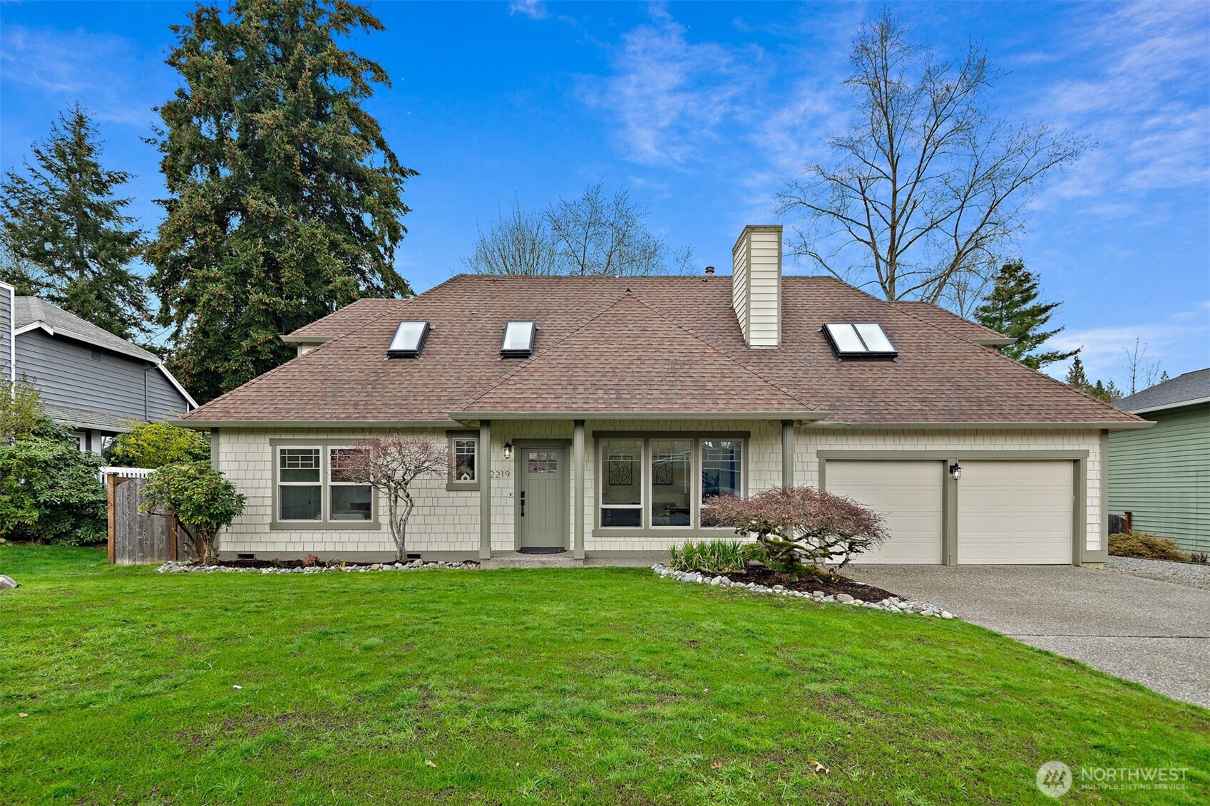 a front view of a house with a garden