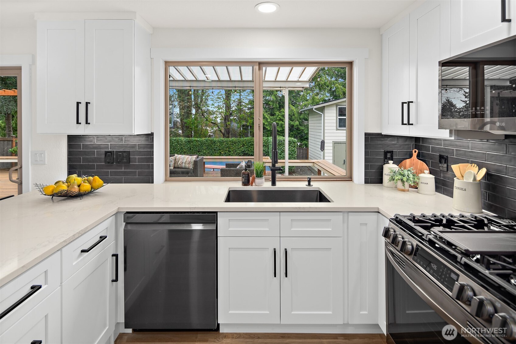 2219 236th Street Southeast Bothell, WA 98021 - Photo 11 of 34 a kitchen with a stove a sink and a window