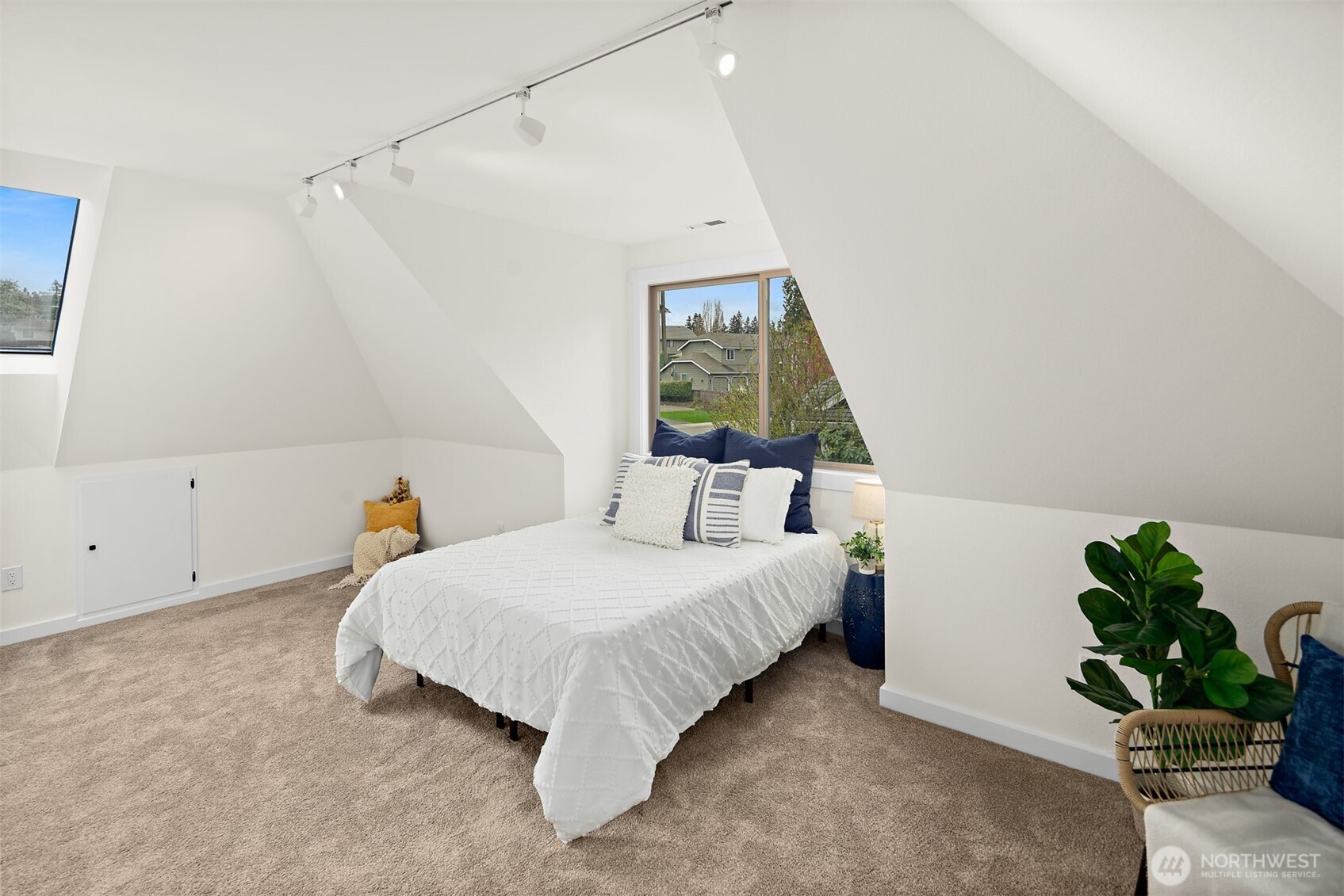 2219 236th Street Southeast Bothell, WA 98021 - Photo 21 of 34 a bedroom with a bed and a potted plant