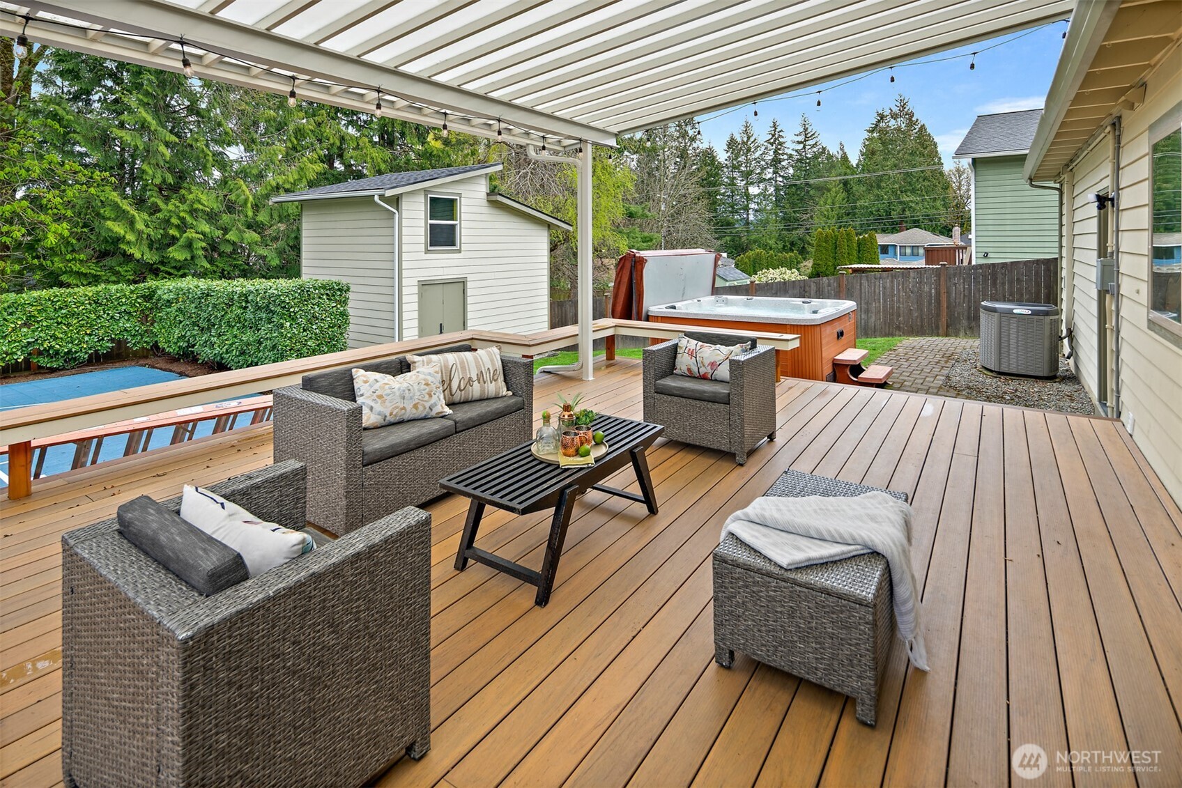 2219 236th Street Southeast Bothell, WA 98021 - Photo 24 of 34 a view of a patio with couches table and chairs with wooden floor and fence