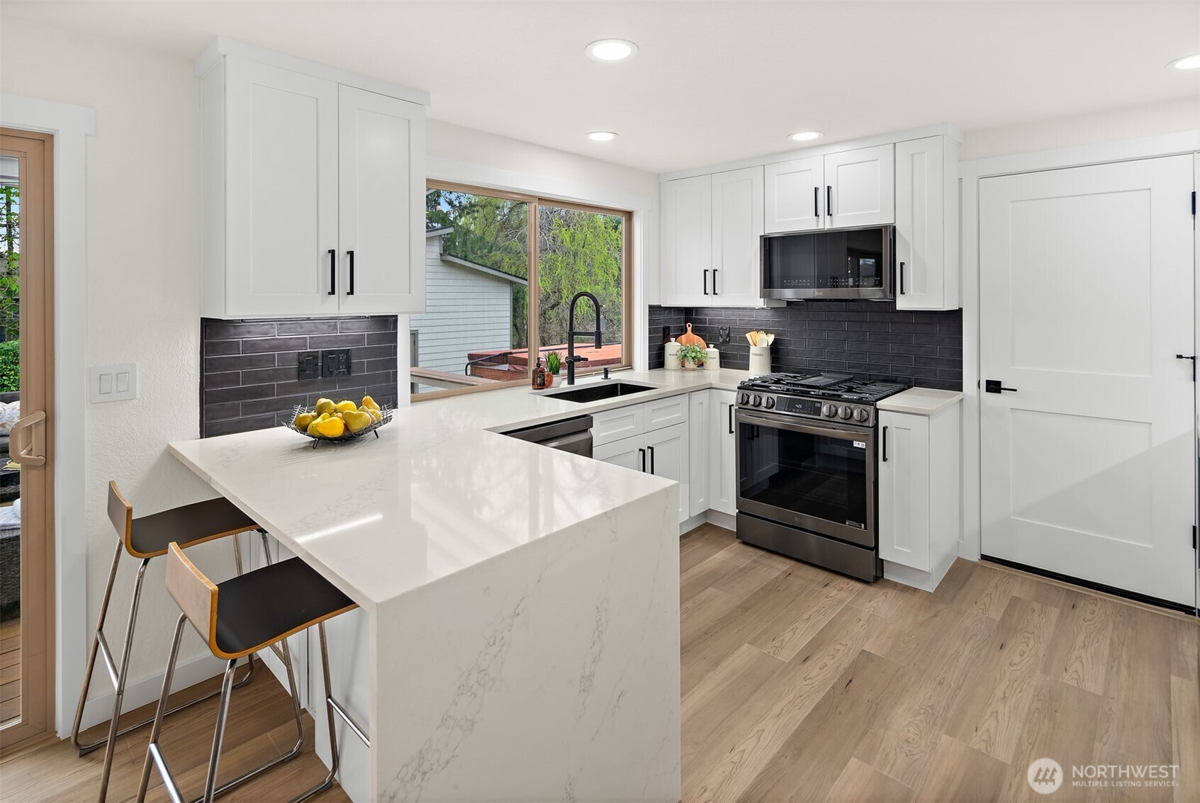 2219 236th Street Southeast Bothell, WA 98021 - Photo 8 of 34 a kitchen with a stove a sink and a refrigerator