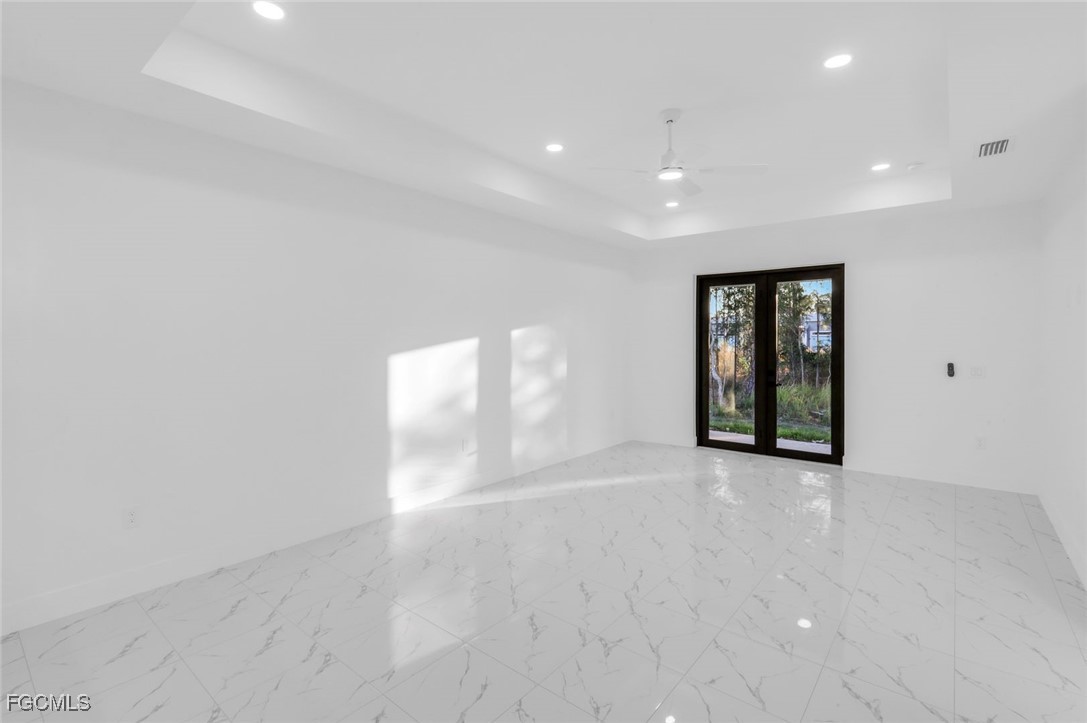 4805-4807 29th Street Southwest Lehigh Acres, FL 33973 - Photo 13 of 25 a view of an empty room with wooden floor and windows