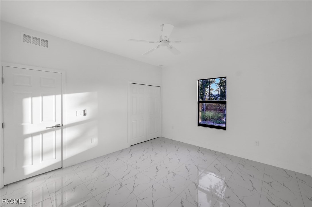 4805-4807 29th Street Southwest Lehigh Acres, FL 33973 - Photo 15 of 25 an empty room with windows and closet