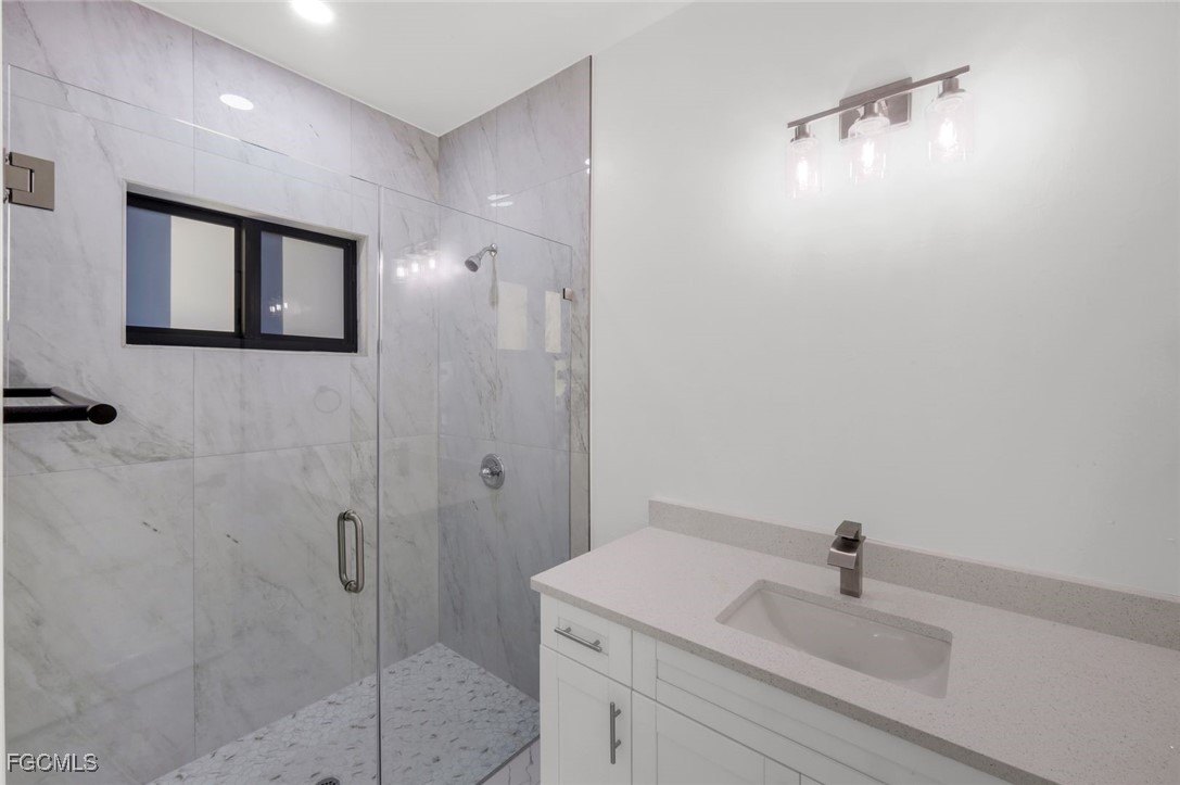 4805-4807 29th Street Southwest Lehigh Acres, FL 33973 - Photo 16 of 25 a bathroom with a sink a light fixture and a vanity