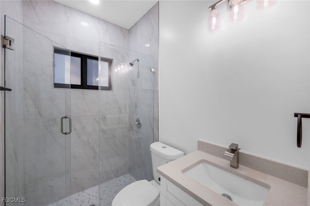 4805-4807 29th Street Southwest Lehigh Acres, FL 33973 - Photo 18 of 25 a bathroom with a sink a toilet and shower