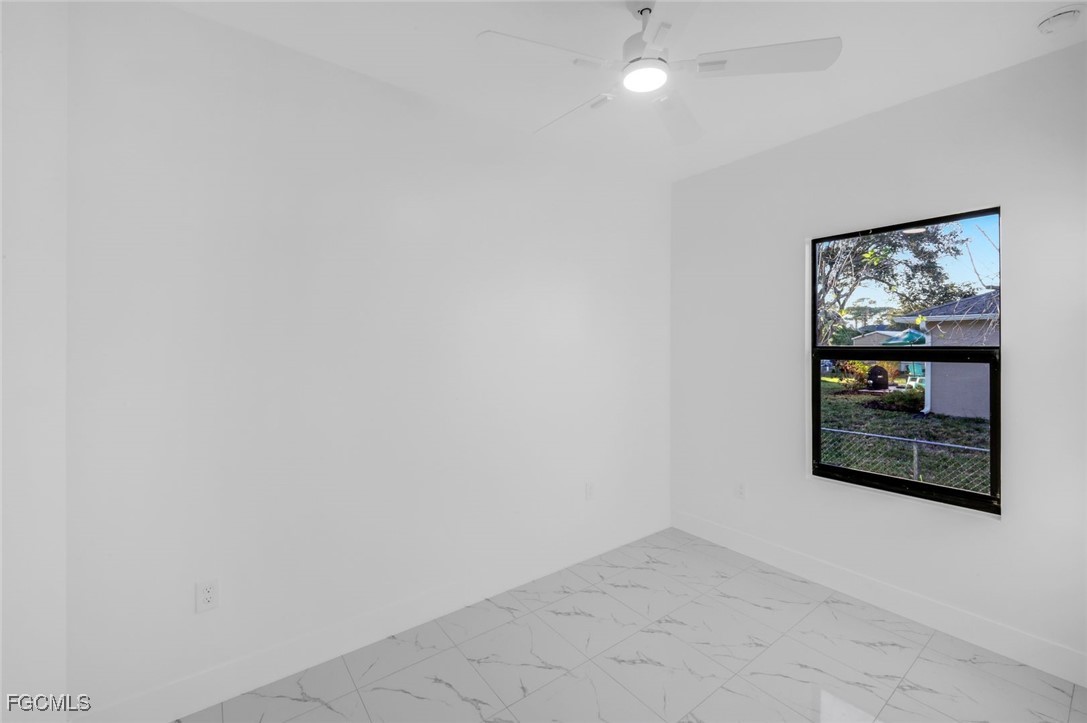 4805-4807 29th Street Southwest Lehigh Acres, FL 33973 - Photo 19 of 25 an empty room with a hallway