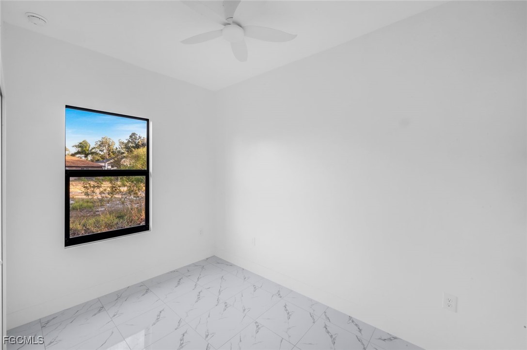 4805-4807 29th Street Southwest Lehigh Acres, FL 33973 - Photo 22 of 25 an empty room with a painting on the wall