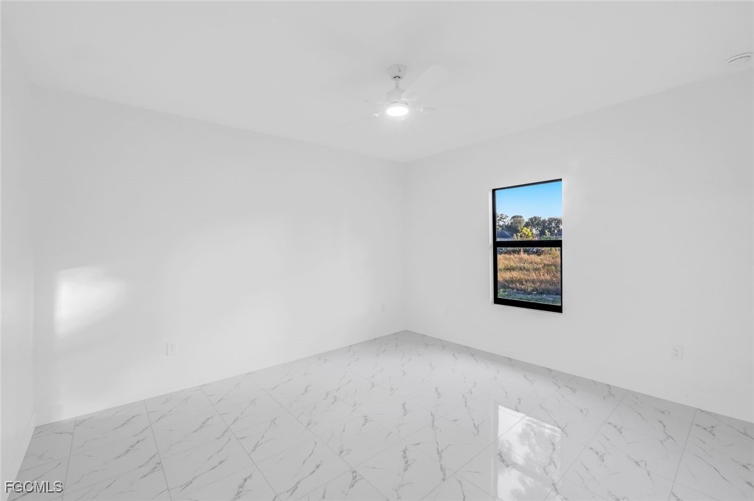 4805-4807 29th Street Southwest Lehigh Acres, FL 33973 - Photo 23 of 25 an empty room with windows