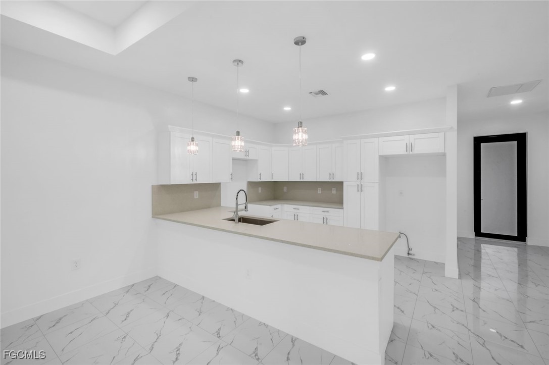 4805-4807 29th Street Southwest Lehigh Acres, FL 33973 - Photo 7 of 25 a large kitchen with a sink stainless steel appliances and cabinets