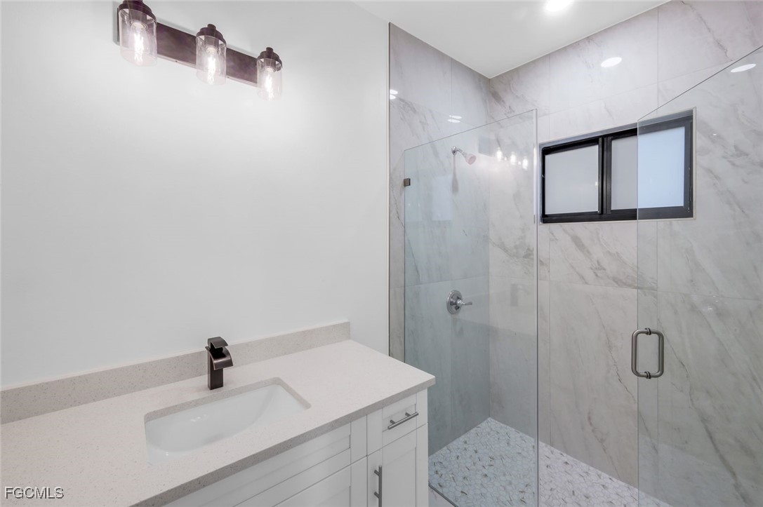 4805-4807 29th Street Southwest Lehigh Acres, FL 33973 - Photo 10 of 25 a bathroom with a sink a toilet and shower