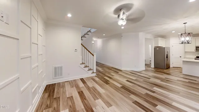 a view of an empty room and wooden floor
