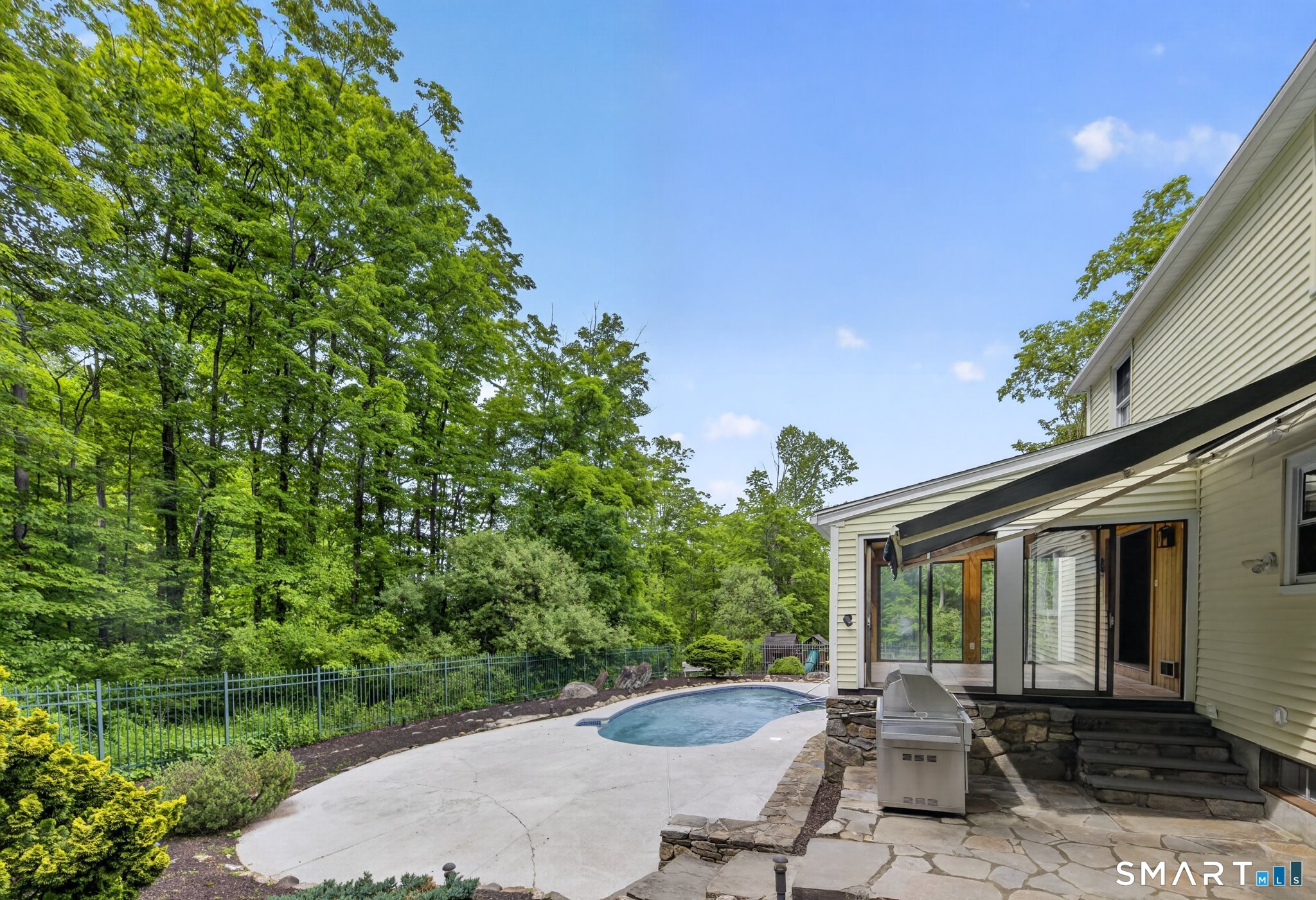 70 Barrack Hill Road Ridgefield, CT 06877 - Photo 25 of 32 a view of a patio with table and chairs with plants and wooden fence