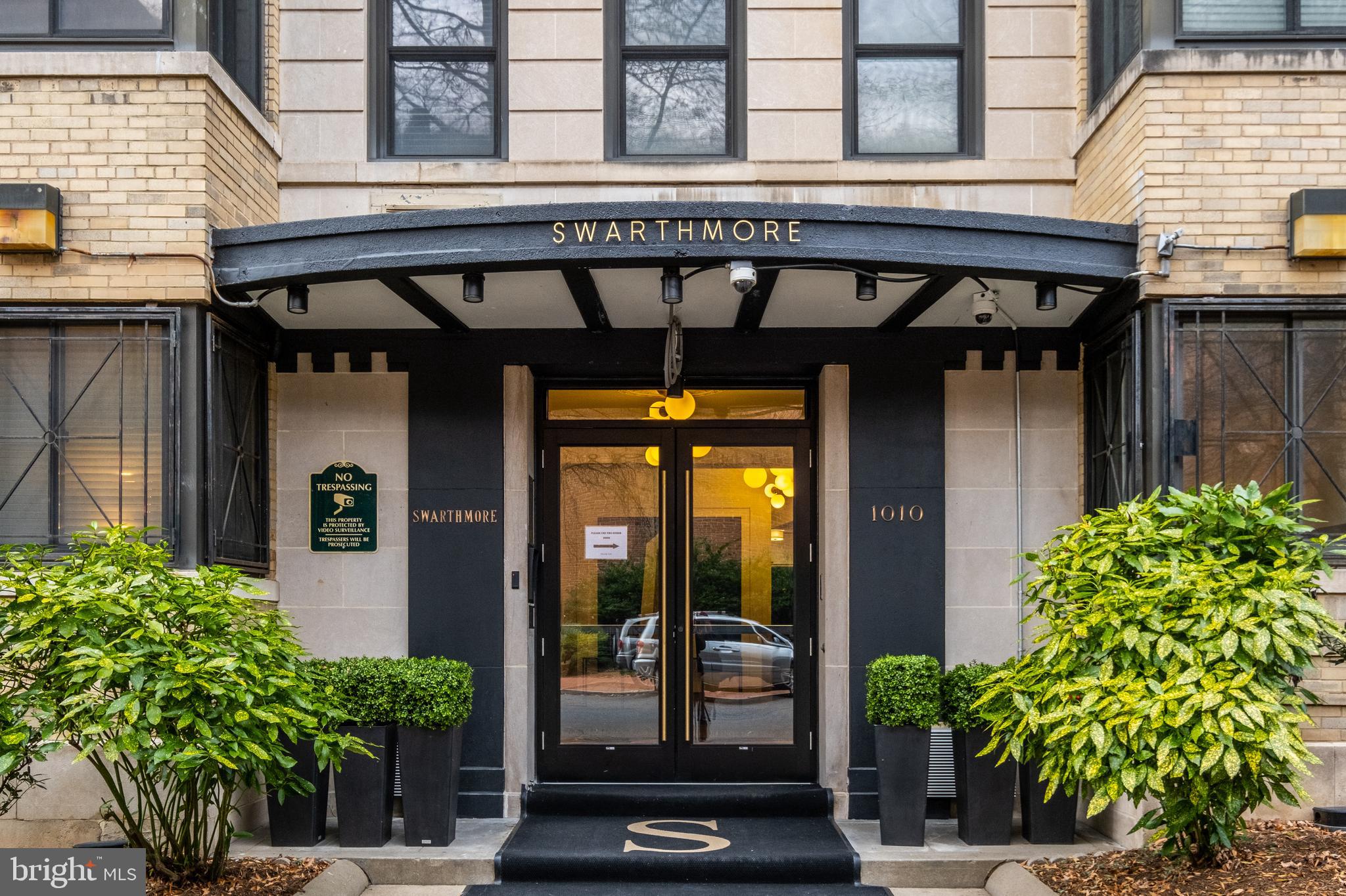 a front view of a building with potted plants