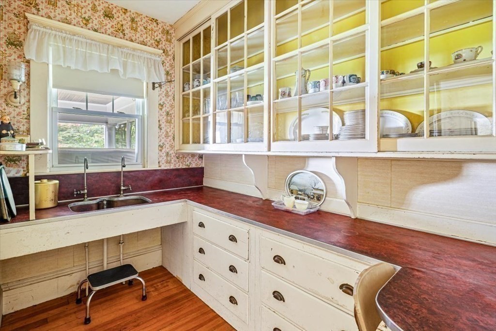 48 Neal Gate Street Scituate, MA 02066 - Photo 12 of 34 a kitchen with granite countertop a sink and a wooden floor